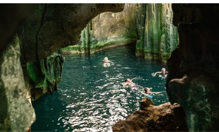 Tropical lagoon surrounded by lush green cliffs and waterfalls in Fiji
