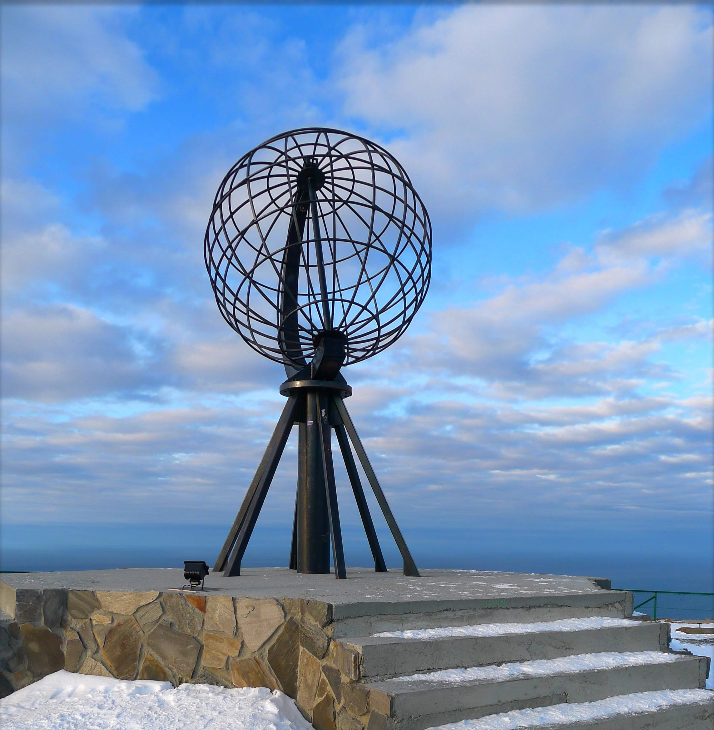 The iconic globe monument at the North Cape overlooking the Barents Sea.