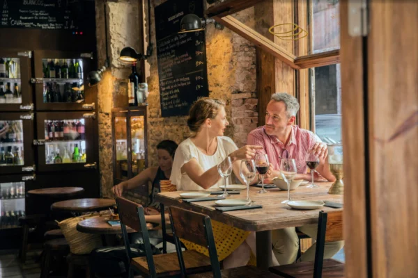 Couple enjoying an elegant specialty dining experience at a warm-lit P&O Cruises restaurant onboard.