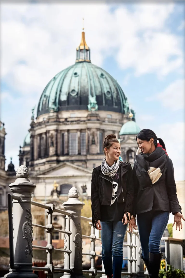 Two travelers exploring historic European architecture during a cruise port stop.