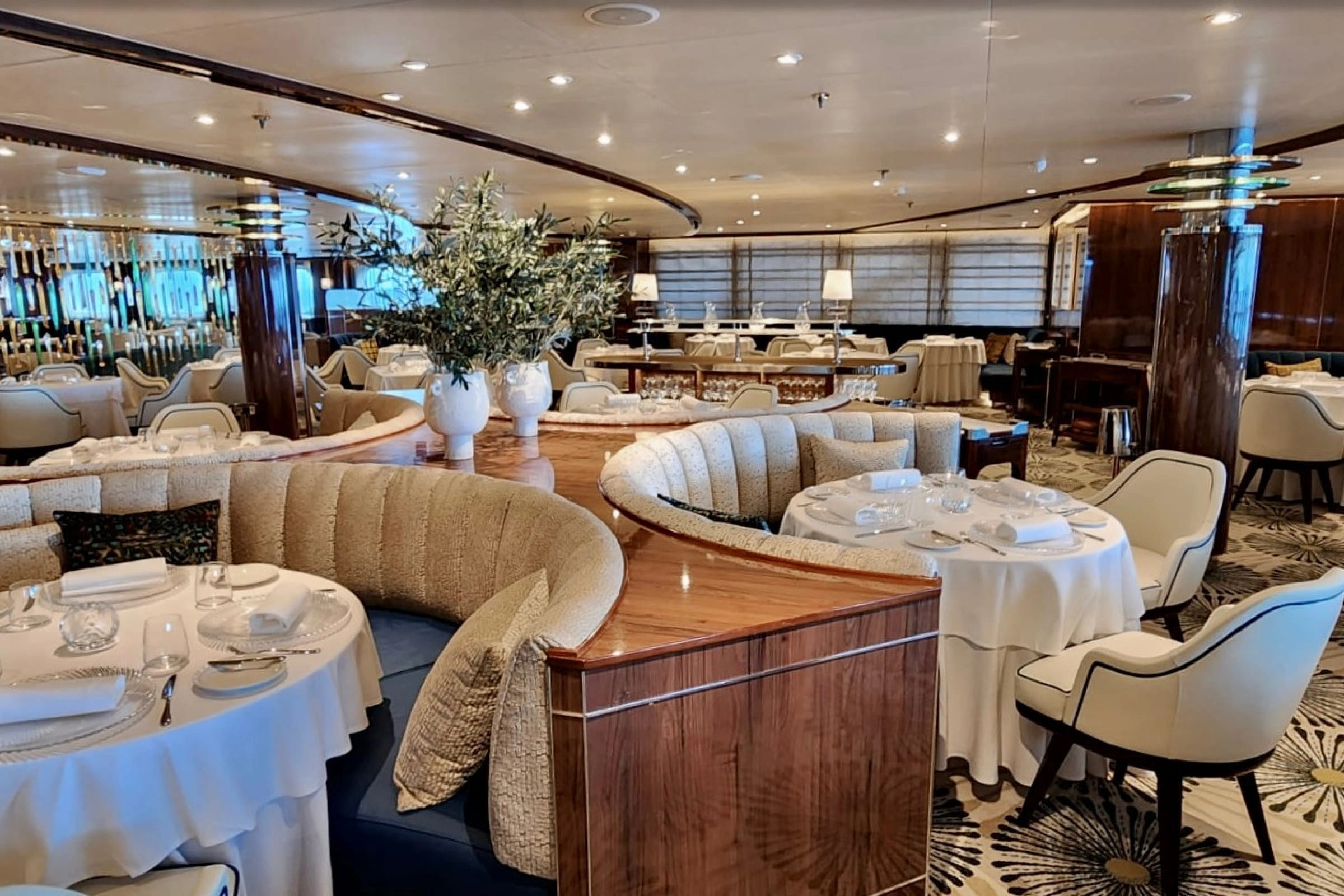 Elegant cruise ship dining room with refined table settings and fine dining atmosphere.