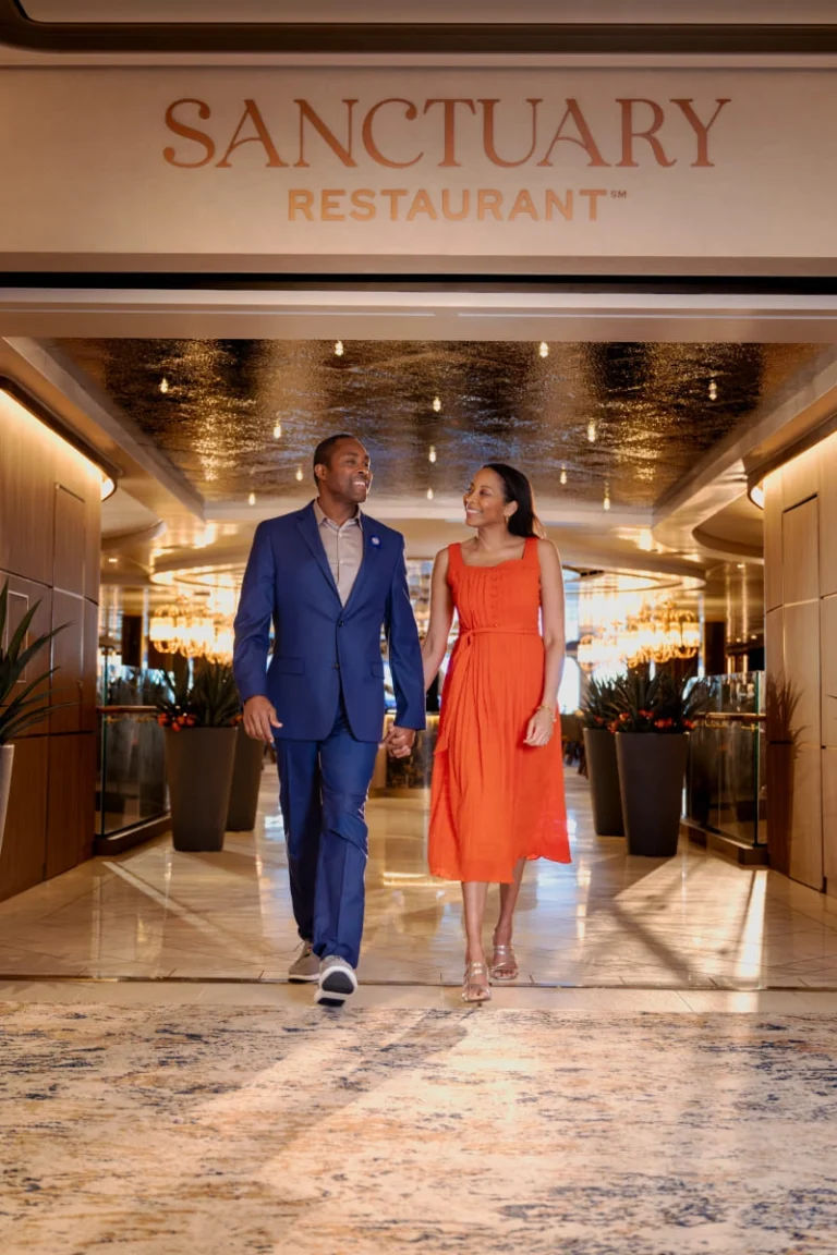 A couple walking through the elegant, spa-like entrance of the Sanctuary area.