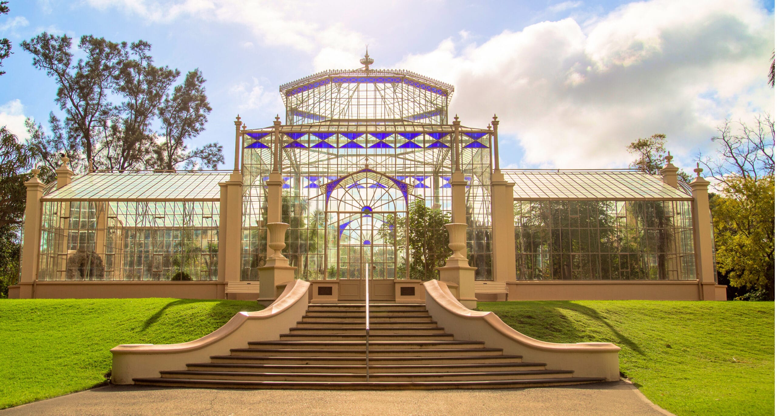 Historic luxury estate glasshouse and manicured gardens.