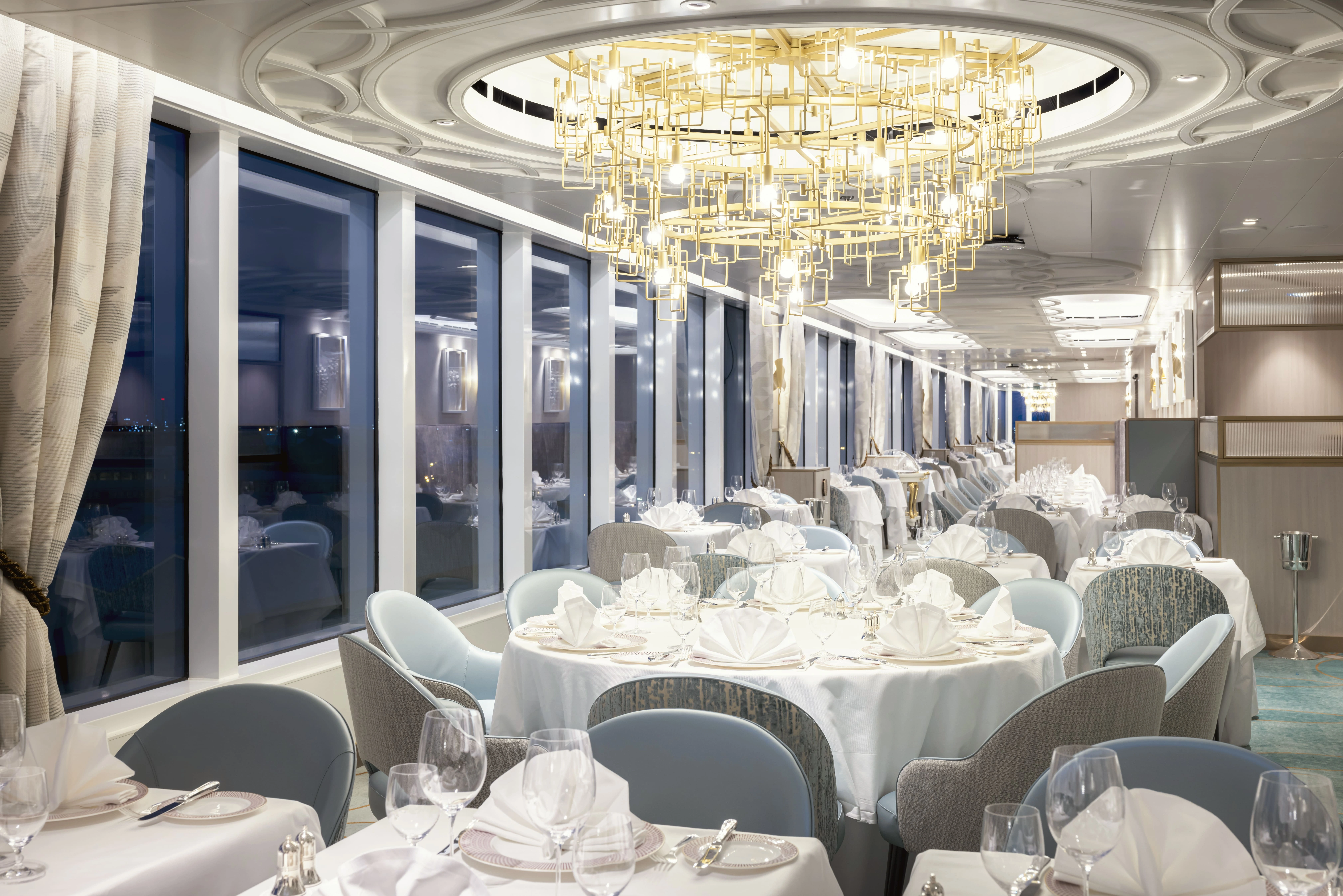 Elegant dining restaurant aboard a Cunard cruise ship offering fine dining, premium cuisine, and sophisticated ambience.