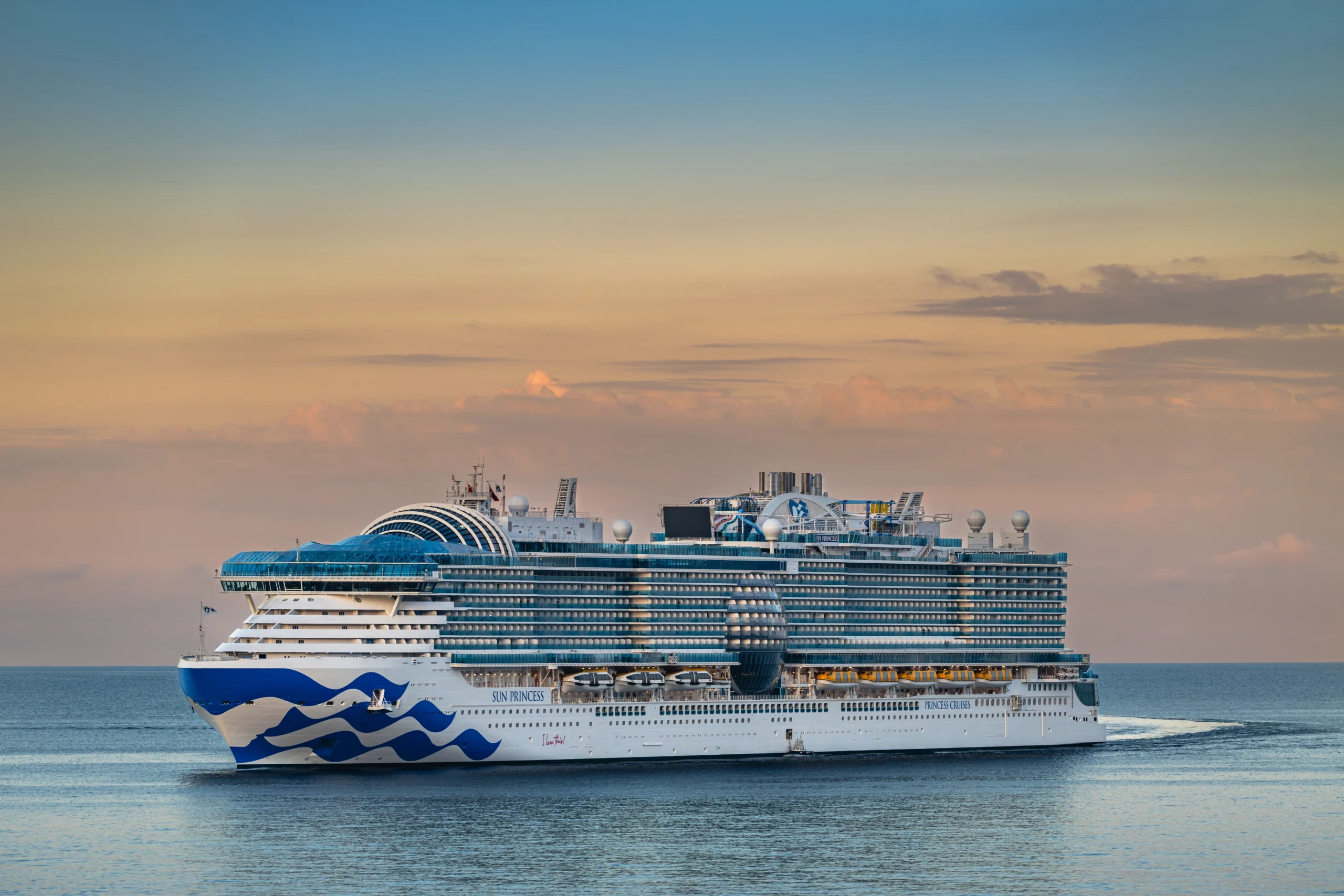 What Kind of a Cruiser are you?- Princess Cruises ship sailing gracefully on calm ocean waters against a warm sunset sky.